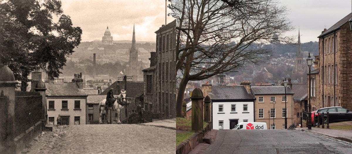 two views looking down the same street 100 years apart. In the foreground of the old photo a cobbled street is lined by stone houses on the right and trees to the left, behind iron railings connecting stone pillars. In the modern photo the railings have been removed but the stone pillars remain. Tarmac covers the cobbles. In the old photo a man is riding a cart horse in the middle of the street. In the new one there's a delivery van and several parked cars. The view across the valley in the background is much the same, including the spire of the cathedral and the domed ashton memorial building on the skyline. 