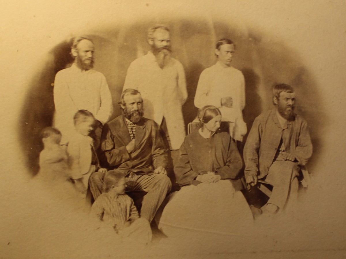 photo of a group of people: 5 men, one woman and 3 children.