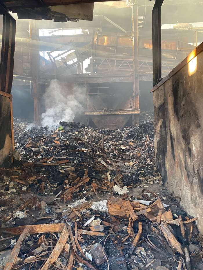 Waste continues to burn inside the former SupaSkips building