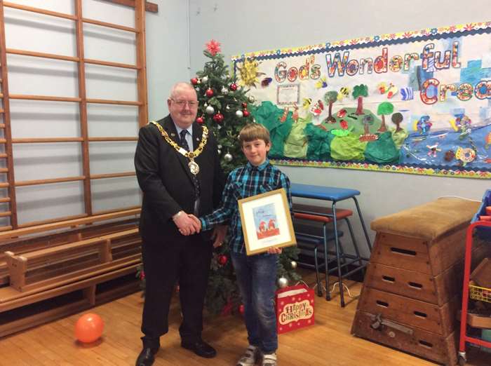 The Mayor of Lancaster, Coun Robert Redfern, presents a framed copy of his winning design to Boaz Hughes