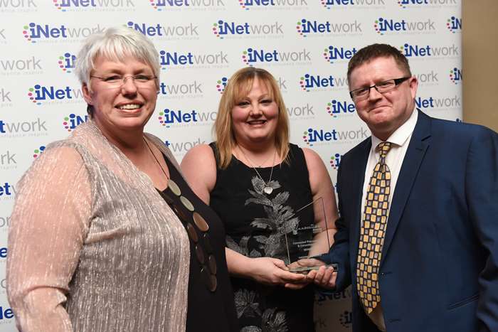 Wendy Clarke (judge), presents the award to Helen McMahon (procurement manager) and Stuart Glover (Sports Development & Facilities Manager).