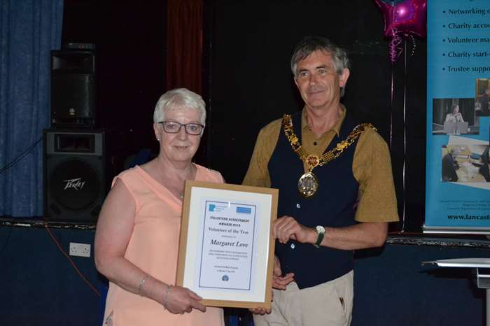 Margaret Love receives her Volunteer of the Year award from the Mayor of Lancaster, Coun Andrew Kay